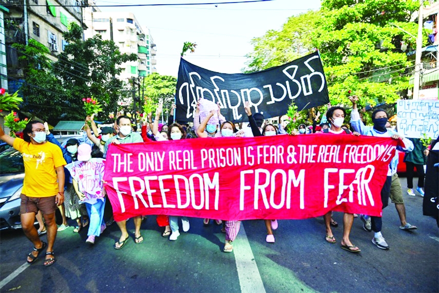 Protesters hold banners as they take part in a demonstration against the military coup in Yangon, Myanmar on Sunday.