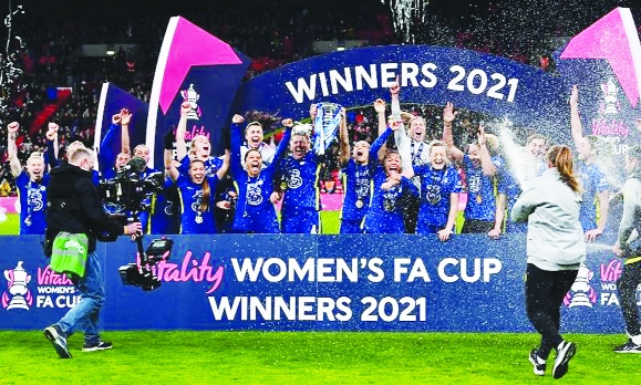 Chelsea's players celebrate with the trophy on the pitch after the English Women's 2021 FA Cup final football match between Arsenal and Chelsea at Wembley Stadium in London on Sunday.