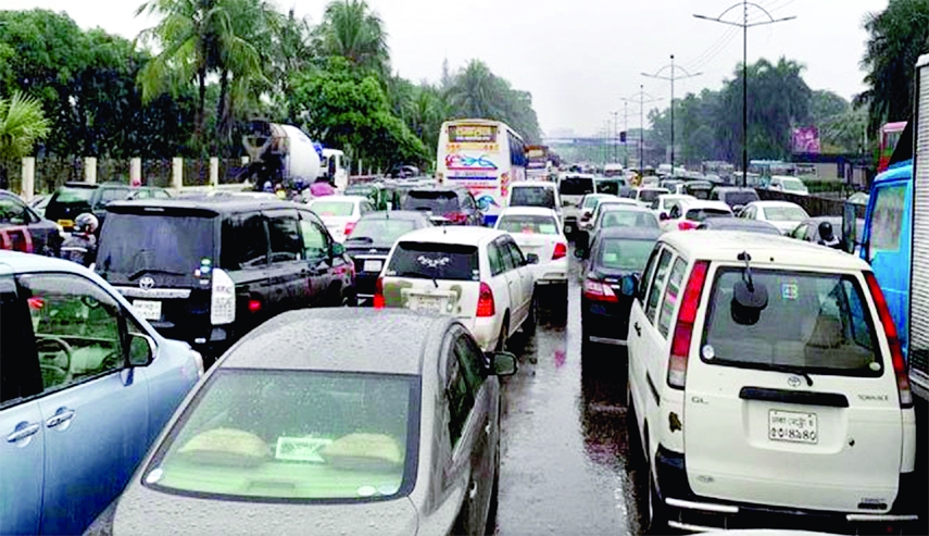 Hundreeds of vehicles get clogged at the Abdullahpur area in the outskirt of the capital on Monday due to heavy traffic congestion created by incessant rains.