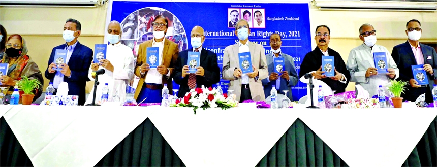 BNP Secretary General Mirza Fakhrul Islam Alamgir along with others holds the copies of a book titled 'Disenfranchisement Under the Authoritarian Regime 2007-2021' at its launching ceremony at Hotel Lakeshore in the city on Friday.