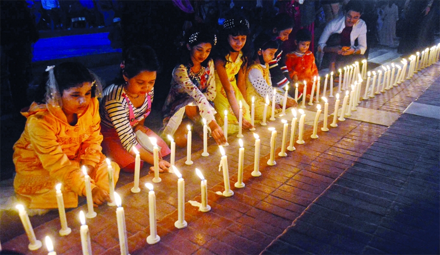 Children lit candles at a function organised by Naripokkho at the Central Shaheed Minar in the capital on Friday against repression on women and children.