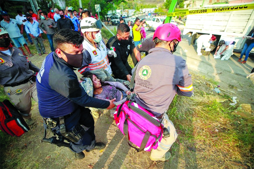 An injured woman is moved by rescue personnel from the site of a truck crash near Tuxtla Gutierrez, Chiapas State, Mexico.