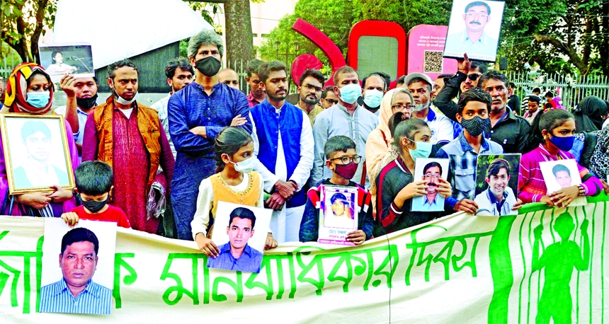 Relatives of the victims of enforced disappearance hold photos of the victims during a rally organised by Mayer Daak at Shahbagh in the capital on Friday marking the International Human Rights Day 2021.