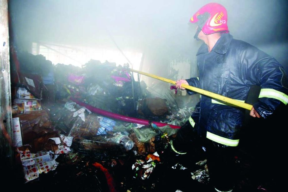 A firefighter dousing fire at old town's Suritola in the capital on Sunday. NN photo