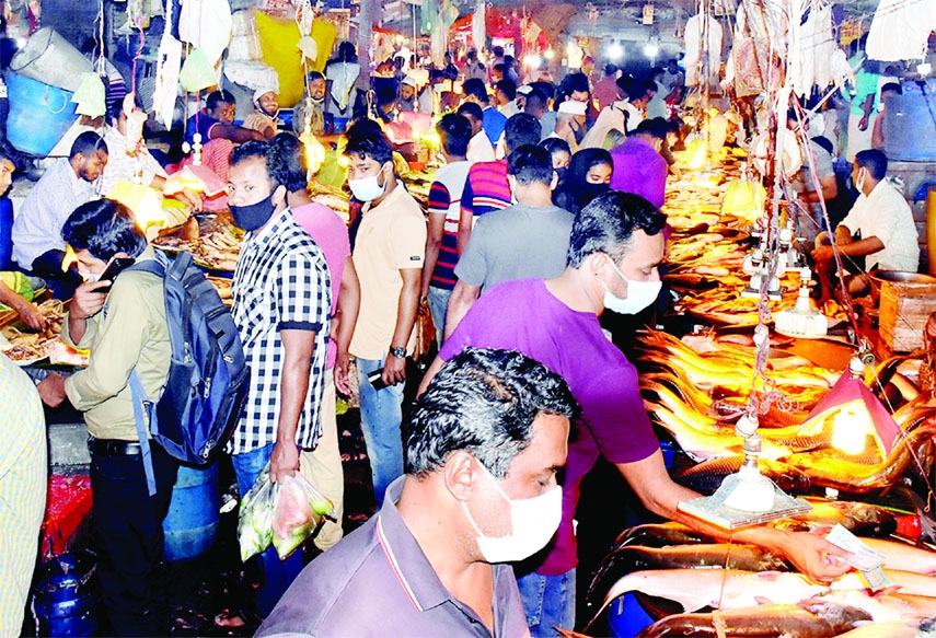 Customers throng Karwan Bazar in the capital on Sunday amid price hike of fish and Sonali Chicken.