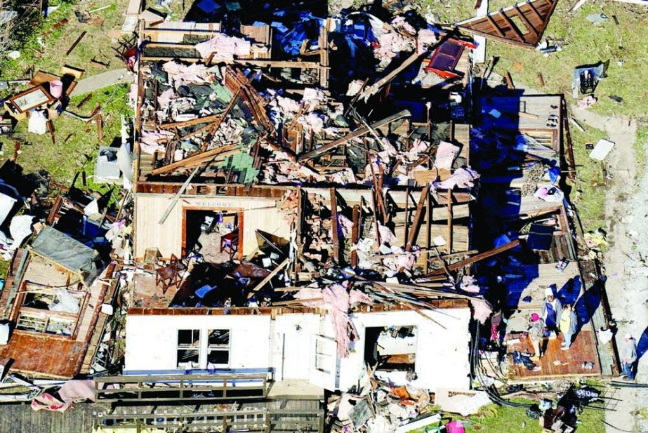 In this aerial photo, people stand on the porch of a destroyed home in the aftermath of tornadoes that tore through the region, in Dresden, Tennessee, US on Monday. Agency photo