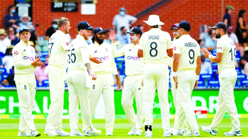 England players celebrate taking the wicket of Australia's Marnus Labuschagne during the 2nd day play of the second Ashes Test in Adelaide, Australia on Friday.