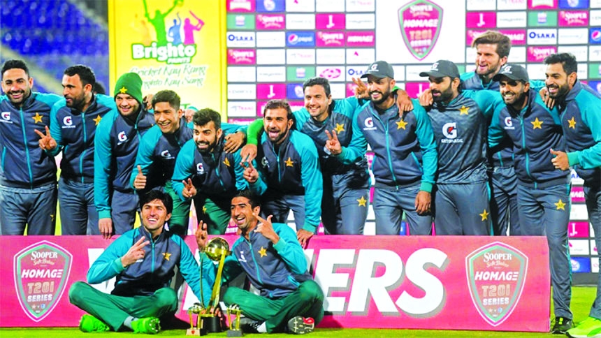 Pakistan's players celebrate with the trophy after winning the three-match T20I series against West Indies at the National Stadium in Karachi on Thursday.