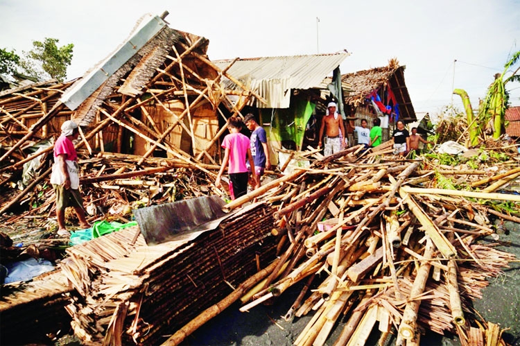 Residents salvage belongings from their destroyed homes in the coastal town of Dulag in Leyte province on December 17, 2021, a day after Super Typhoon Rai hit.