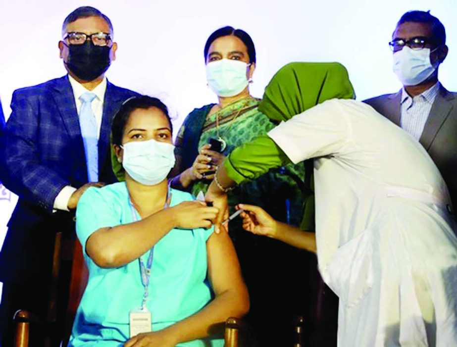 Runu Veronica Costa, a nurse at Kurmitola General Hospital in the capital, becomes the first person in Bangladesh to receive a Covid booster dose as the country launched the programme on Sunday. NN photo