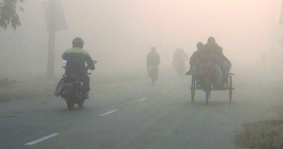 Vehicles ply on a foggy road in Panchagarh on Sunday amid a mild cold wave that is sweeping over the district. NN photo