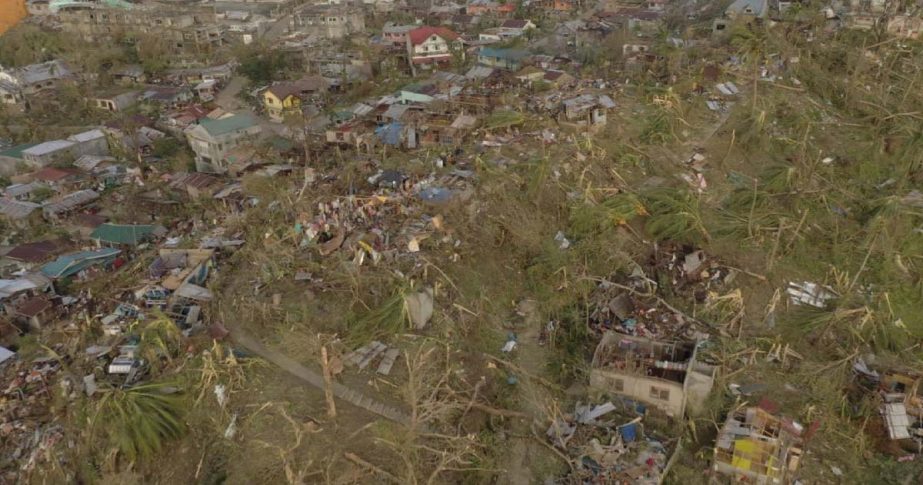 n this photo provided by the Philippine Navy, damaged houses and toppled trees lie in Dinagat Island, Surigao del Norte province, southern Philippines on Friday, Dec. 17, 2021.