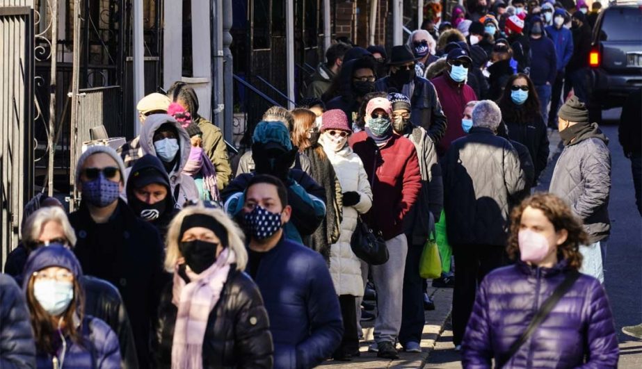 City residents wait in a line extending around the block to receive free at-home rapid COVID-19 test kits in Philadelphia, Monday, Dec. 20, 2021. AP photo