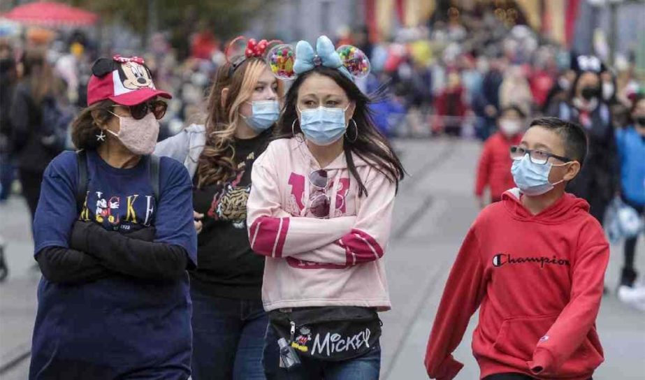 Visitors wearing face masks walk down Main Street USA at Disneyland in Anaheim, Calif., Monday, Dec. 27, 2021.AP photo