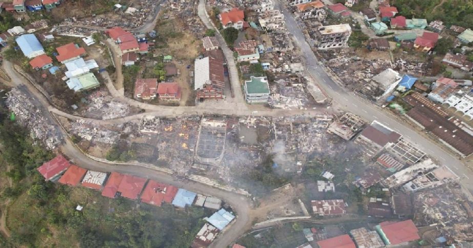 In this aerial photo released by the Chin Human Rights Organization, fires destroy numerous buildings in the town of Thantlang in Chin State in northwest Myanmar, on Dec. 4, 2021.