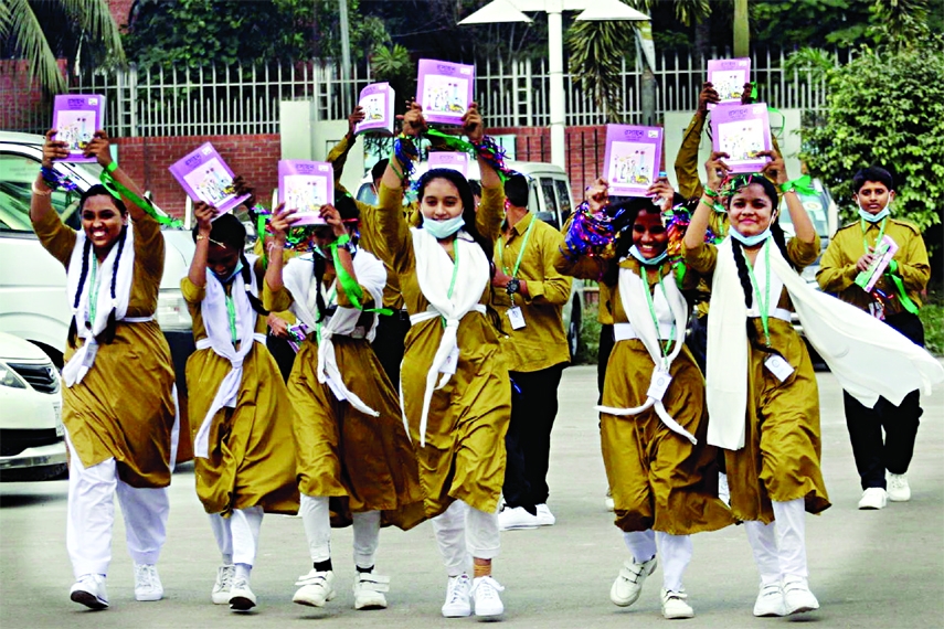 Students happy after getting new books for the New Year in front of Bangabandhu International Conference Centre on Thursday.