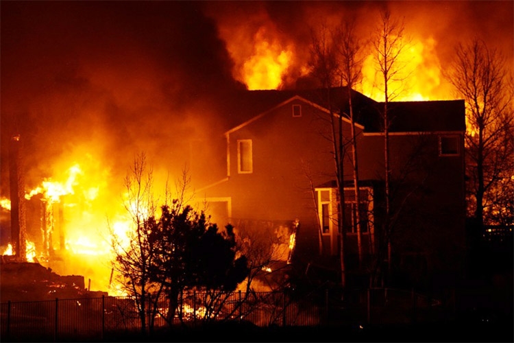 Homes burn as wildfires rip through a development on Thursday, December 30, 2021, in Superior, Colo.