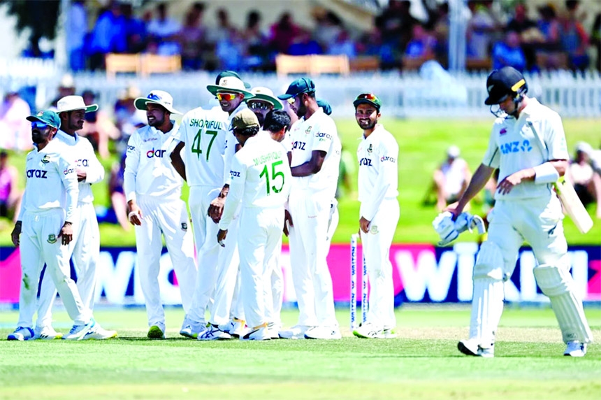 Bangladesh cricketers celebrate after dismissal of Will Young (right) of New Zealand during the day 1 play of the first Test between Bangladesh and New Zealand at Mount Maunganui in New Zealand on Saturday.