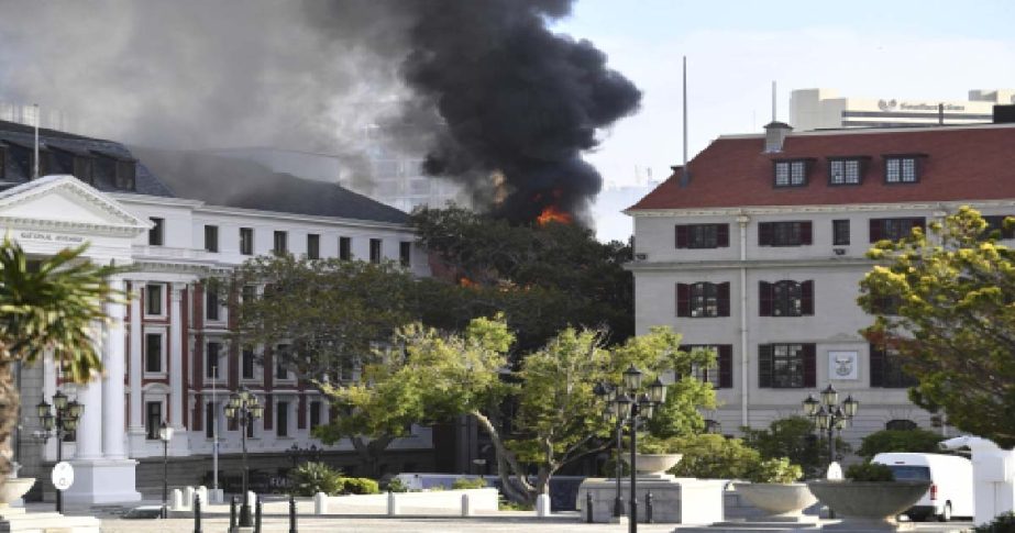 A fire burns at the Houses of Parliament, in Cape Town, South Africa, Sunday, Jan. 2, 2022.