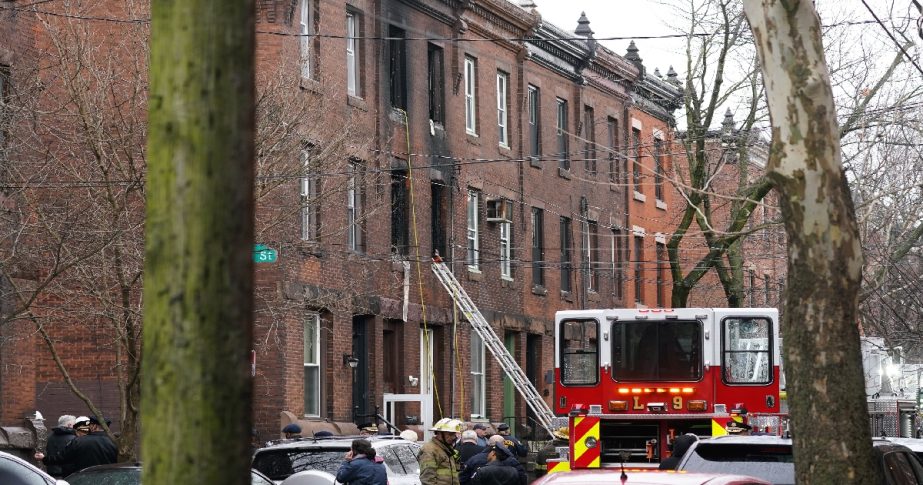 Philadelphia firefighters work at the scene of a deadly row house fire, Wednesday, Jan. 5, 2022, in the Fairmount neighborhood of Philadelphia.