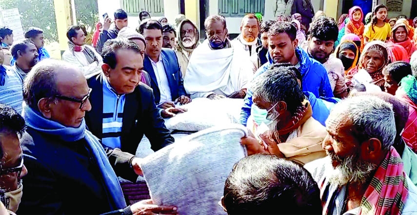 BARAIGRAM (Natore): Prof Abdul Quddus MP distributes blankets among distress people at Baraigram upazila of Natore on Friday.