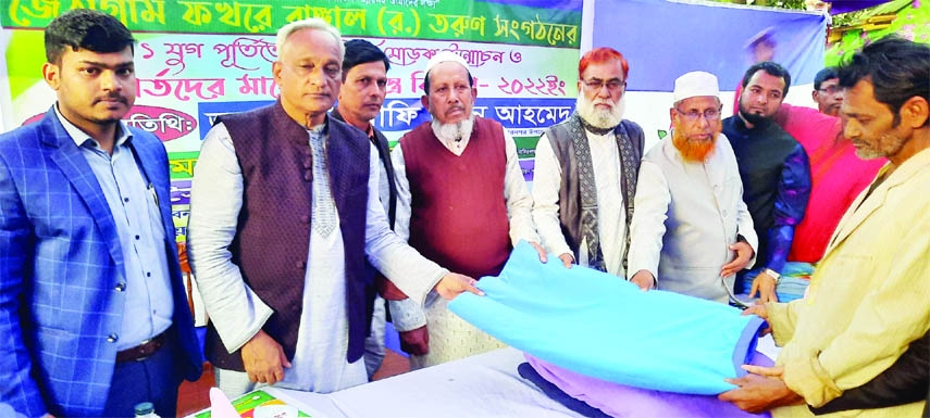 NASIRNAGAR (Brahmanbaria): Rafiuddin Ahmed, Chairman, Nasirnagar Upazila distributes warm clothes among the poor people at Jathagram Purbo Para organised by Phakhra Bangal(R.), a youth organisation on Friday.