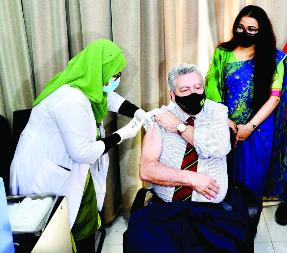 A nurse injects Covid-19 booster dose to a diplomat at the Sheikh Russel Gastroliver Institute & Hospital in the capital on Sunday. NN photo