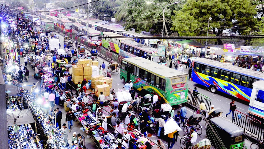 Hawkers sell products illegally occupying a key road at Gulistan in Dhaka on Sunday. As a result, vehicles can not move freely.