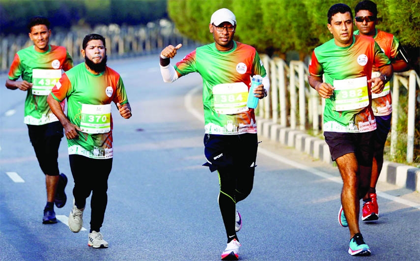 Runners take part in the Bangabandhu Sheikh Mujib Dhaka Marathon-2022 held at the Hatirjheel Amphitheatre in the capital on Monday marking the Father of the Nation's Homecoming Day.