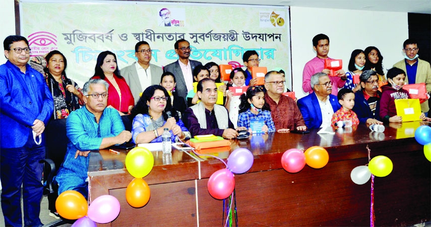Guests pose for a photo session with the winners of painting competition organised on the occasion of Mujib Year and Golden Jubilee of the Independence by the Jatiya Press Club in its auditorium in the city on Friday.