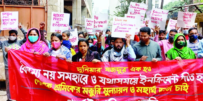 Garments Sramik Sanghati forms a human chain in front of the Jatiya Press Club on Friday to realize its various demands including evaluation of wages of the garments employees.
