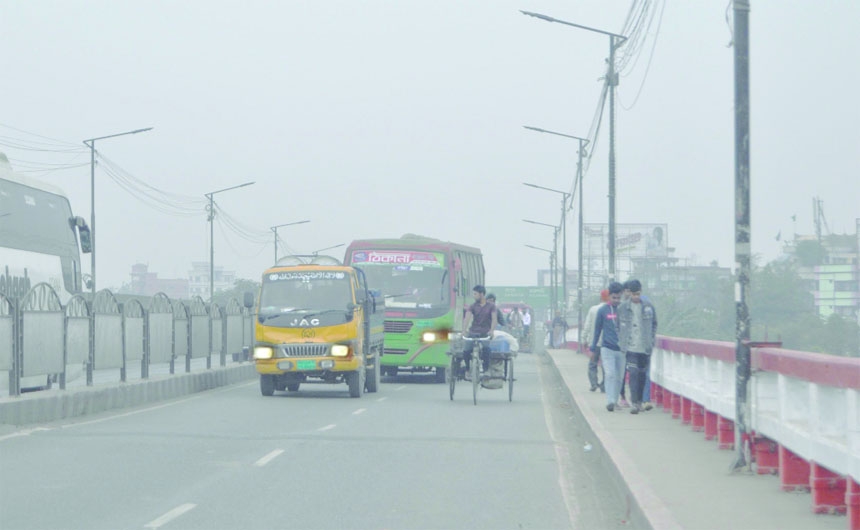 Drivers turn on the head lights of their vehicles during day time due to dense fog. The snap was taken from the city's Amin Bazar area on Friday.