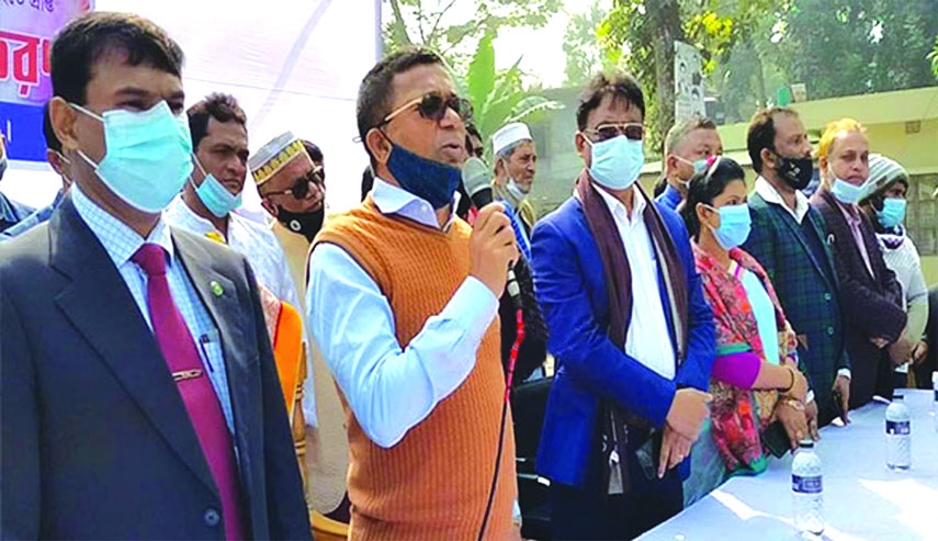 Deputy Minister for Water Resources AKM Enamul Haque Shamim speaks at a ceremony on distributing corrugated tin and cheque among homeless families on Naria Shaheed Minar premises in Shariatpur on Thursday.