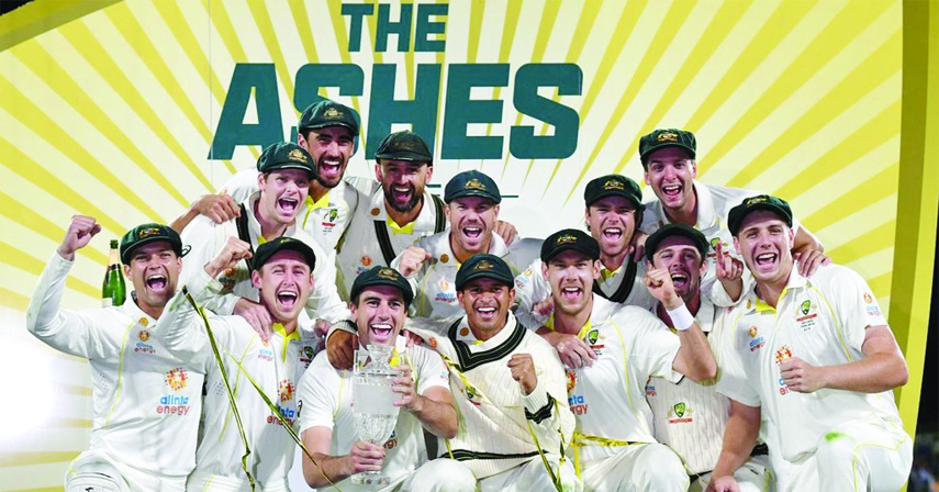 Players of Australia celebrate with the Ashes trophy after beating England at Hobart in Australia on Sunday.