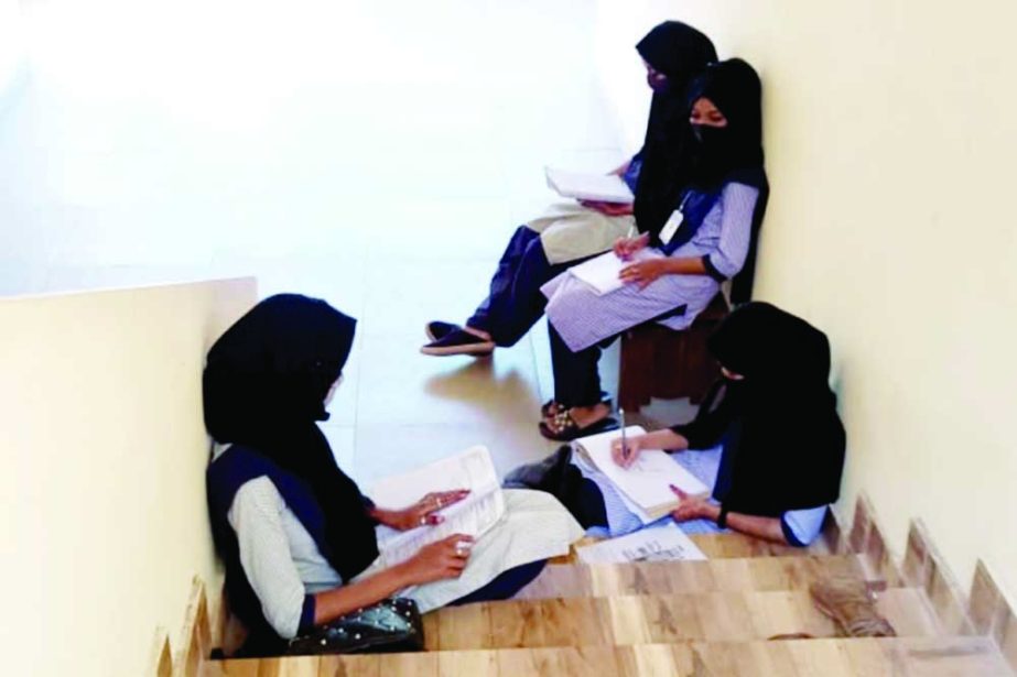 The photo of the girls sitting on the stairs of the college that went viral on social media [Al Jazeera]