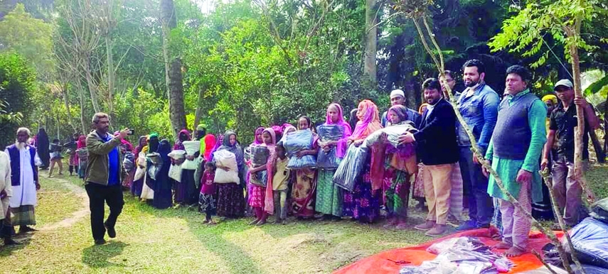 GAFARGAON (Mymensingh) : Winter clothes distributes among the cold-hits at Kaza Village in Langair Union organised by HMBD Foundation on Wednesday.