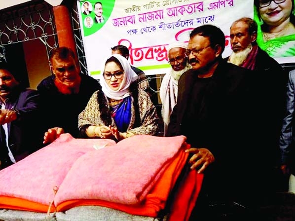 Presidium member of Jatioya Party, Nazma Akter, MP distributes warm clothes among the poor at Panua village under Chhagalnaiya upazila of Feni on Thursday.