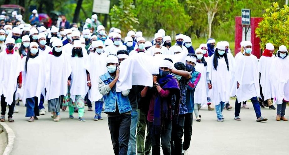 SUST students, who are continuing a "hunger strike until death" in front of the VC's residence demanding his resignation, bring out a silent procession on the campus on Saturday wearing shrouds. NN photo
