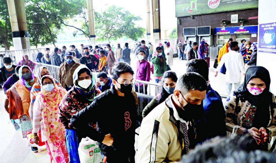 Train passengers stand in a queue in front of a ticket counter of the capital's Kamalapur Railway Station on Sunday without maintaining social distancing protocol despite coronavirus surge in the country. NN photo