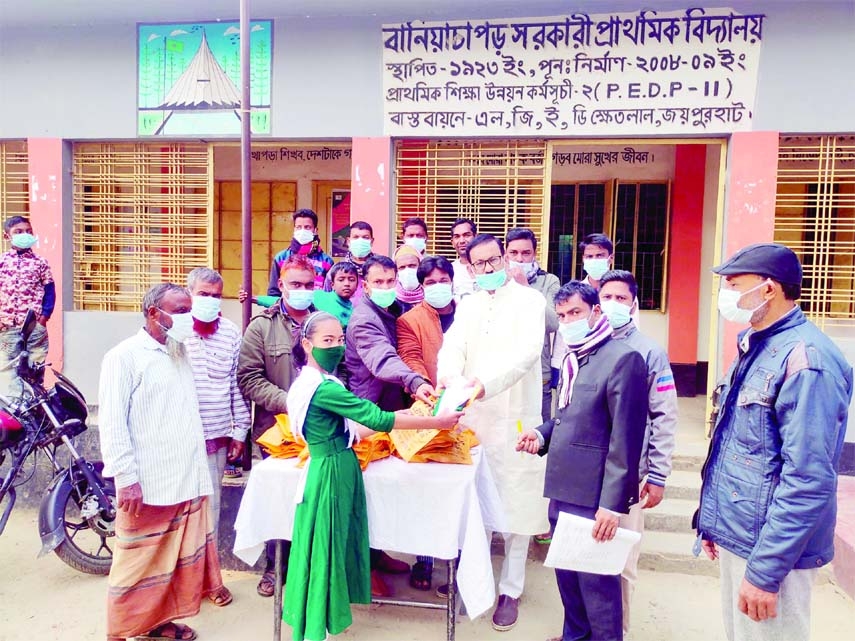 JOYPURHAT: Newly- elected member of Alampur Union of Ward No 9 Abdul Motin Akhand presents new school dresses among the students at Khetlal Upazila on Sunday.