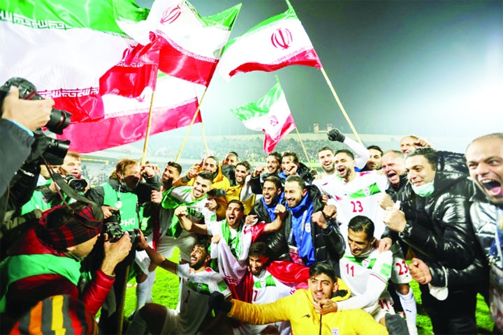 Iran's players celebrate with fans after qualifying for the 2022 Qatar World Cup finals in Qatar on Thursday.