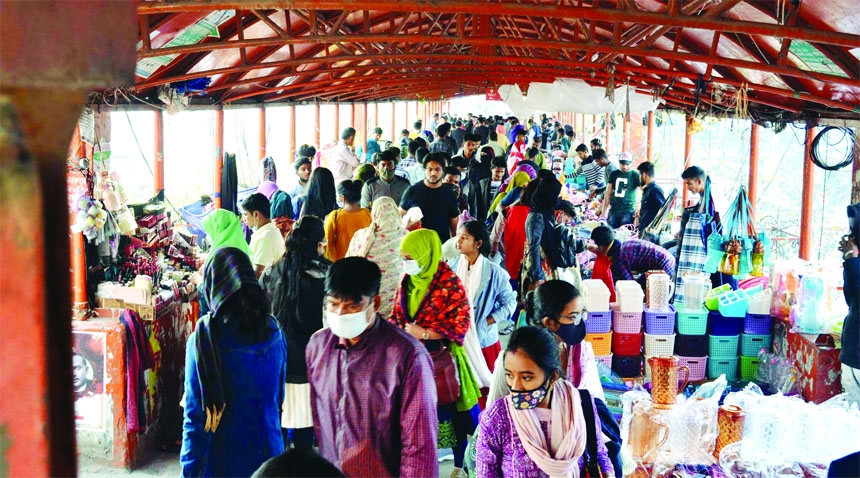 People jostle at New Market over bridge in the capital on Friday to purchase products. Though the government issued instruction to show vaccine certificate in some fields to prevent Omicron, but there is no specific rule that embedded in open markets.