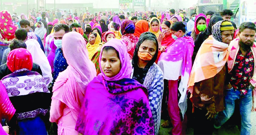 Garments workers block a road in Gazipur on Saturday protesting closure of their factory.