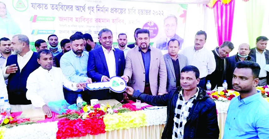 SYLHET: Habibur Rahman Habib MP hands over the keys of house to the beneficiaries at Bagharkhala Village in Lalabazar of Dakshin Surma Upazila built by Lalabazar Union Education Trust (LUET) UK with the help of Zakat Fund on Saturday.