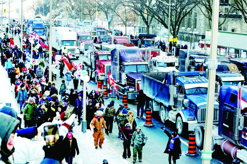 Hundreds of truckers parked trucks on Wellington Street near the parliament buildings in Ottawa, Canada on Saturday.