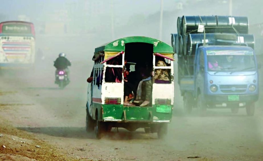 Vehicles ply through a dusty road at Demra area on Tuesday. As the air became very unhealthy in the capital, so it has created serious hazardous living environment. NN photo