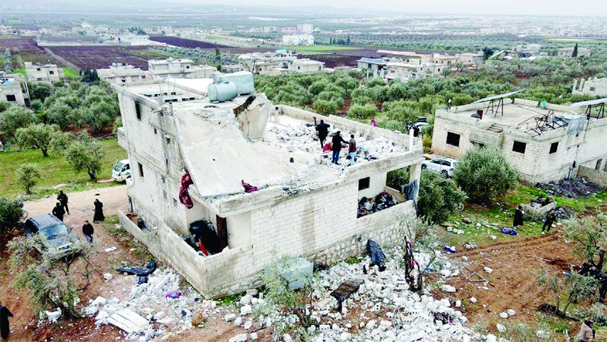 A Syrian civil defence team surveys the damage to a two-storey house on the outskirts of the rebel-held town of Atme on Thursday that appears to have been one of the main targets of the United States raid.
