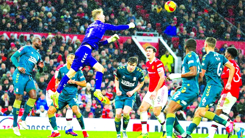 Middlesbrough's English goalkeeper Joe Lumley (center) punches the ball clear during the English FA Cup fourth round football match at Old Trafford in Manchester, north-west England on Friday.
