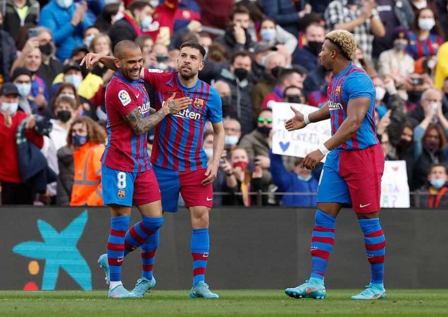 FC Barcelona's Jordi Alba (2nd from left) celebrates scoring their first goal with teammates Dani Alves (left) and Adama Traore during the Spanish league football match at the Camp Nou stadium in Barcelona on Sunday. Agency photo