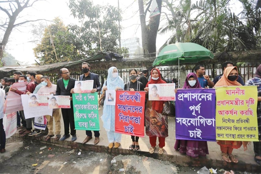 Families of missing disabled children form a human chain in front of the Jatiya Press Club on Friday demanding whereabouts of their wards.